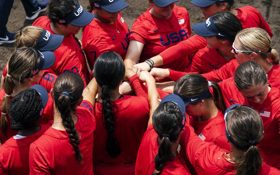 Members of the U.S. Women’s Olympic softball team motivate one another before an exhibition game against the Hitachi Sundivas in Iwakuni, Japan, Monday, July 12, 2021. 