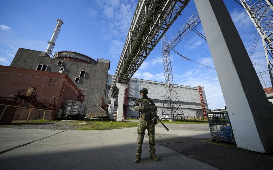 A Russian service member guards in an area of the Zaporizhzhia Nuclear Power Station in territory under Russian military control, southeastern Ukraine, May 1, 2022. The head of the U.N. nuclear watchdog says Ukraine’s Zaporizhzhia Nuclear Power Plant has switched to emergency diesel generators after losing  its external power supply for the seventh time since Russia’s full-scale invasion. 