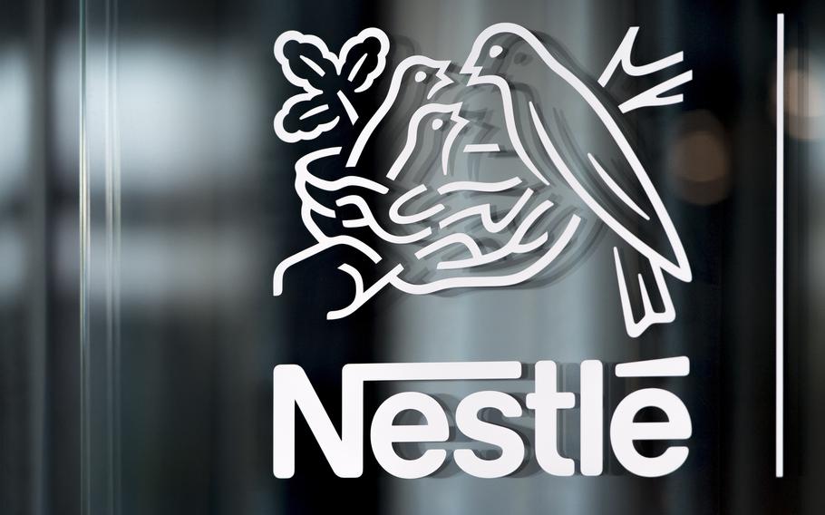 Nestle’s logo in white against a window.
