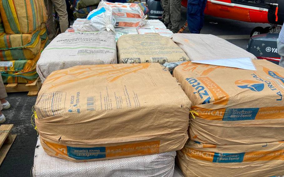 Packages of cocaine and marijuana are stacked on the deck of the U.S. Coast Guard Cutter James Thursday, Feb. 17, 2022.