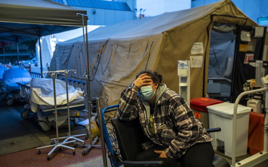 Carina Tapia waits in the ambulance bay outside the Emergancy Department at MLK Community Hospital on Jan. 13, 2022 in the Willowbrook neighborhood of Los Angeles.