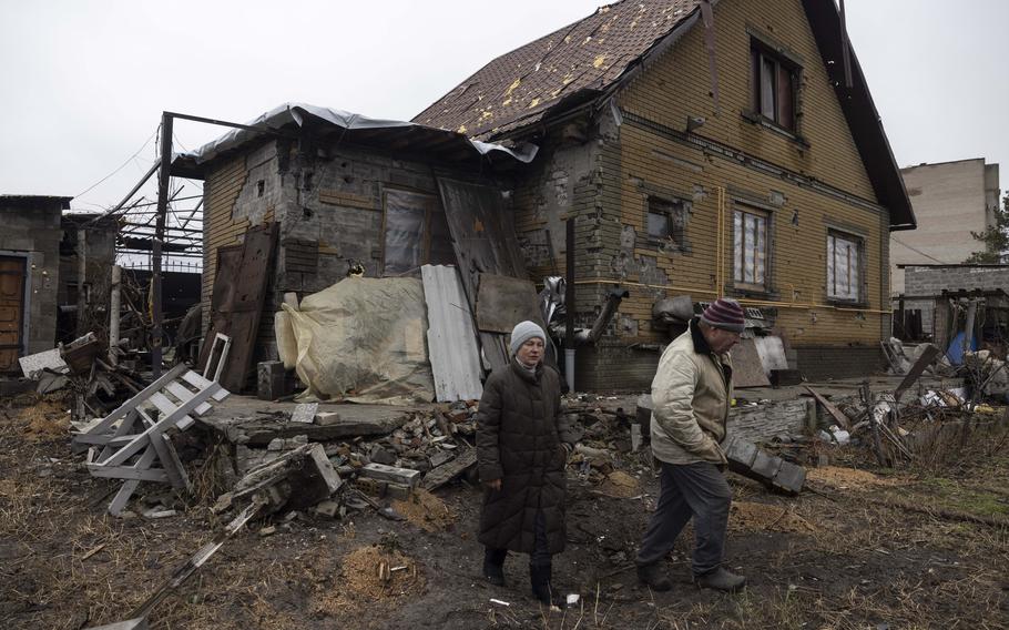 Tamara Klimashenko, 61, and her husband Anatoly Klimashenko, 62, visit their damaged home in Lyman, Ukraine, on Dec. 18.