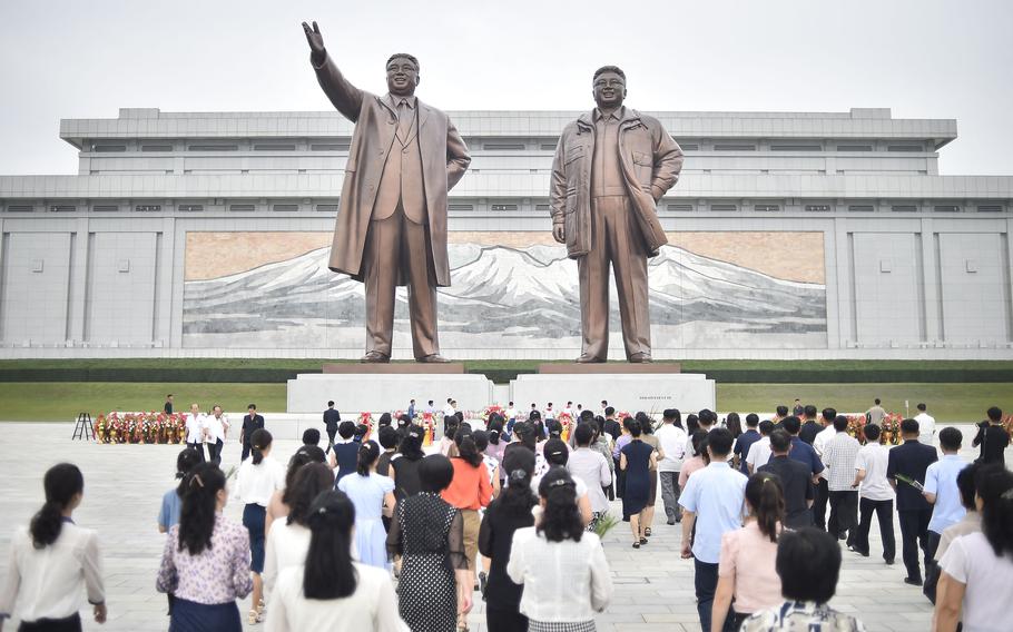 People pay their respects before the statues of late North Korean leaders Kim Il Sung and Kim Jong Il as North Korea marks its 75th founding anniversary at Mansu Hill in Pyongyang on Sept. 9, 2023.
