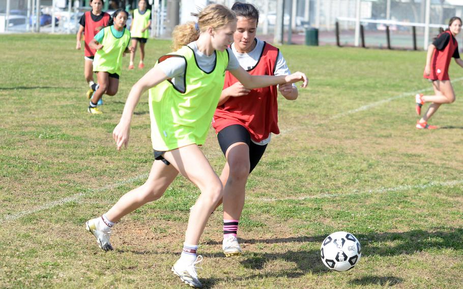 Junior Emma Leggio, in green, is trying her hand at soccer after helping Kubasaki's volleyball team go unbeaten.