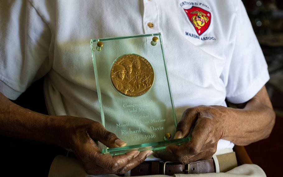 Rich Davis, 97, holds his Congressional Gold Medal as one of the last surviving Montford Point Marines, a Black World War II unit, on Wednesday, May 24, 2023. 