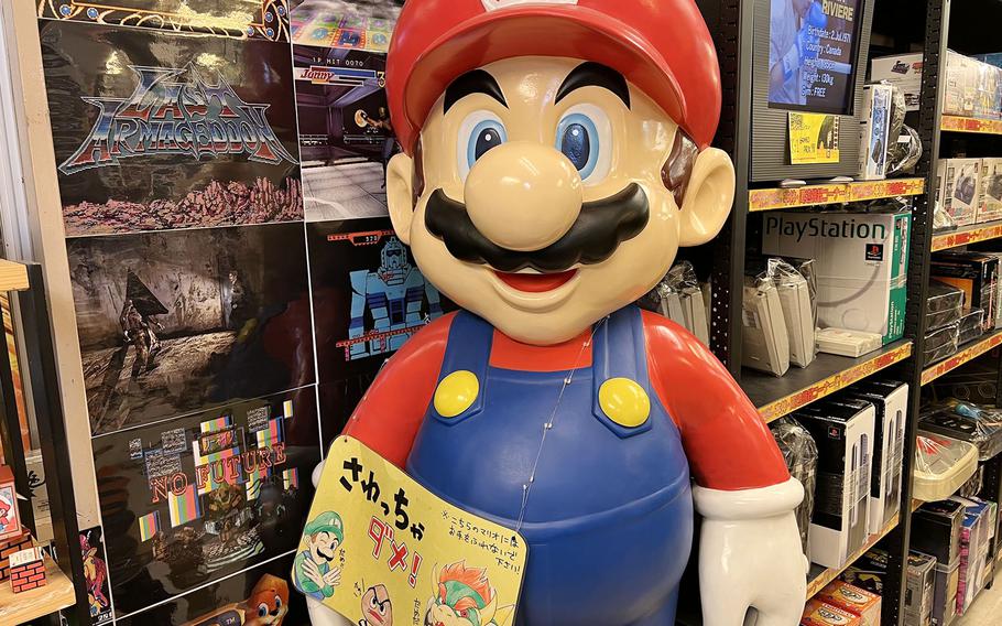 Mario greets customers as they enter the Super Potato retro video-game shop in Akihabara, Tokyo, Nov. 30, 2021. 