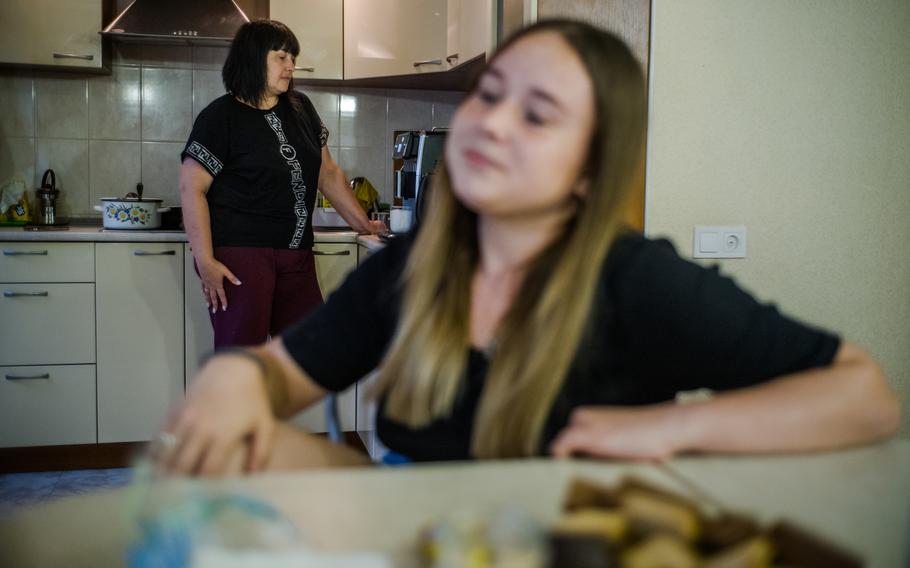 Mykola Khanatov's wife, Rimma, left, and 17-year-old daughter, in their apartment this month. 