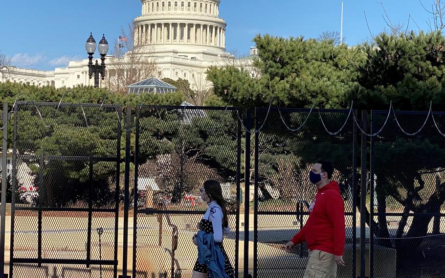 Pedestrians walk past the U.S. Capitol in Washington, D.C. on March 16, 2021.