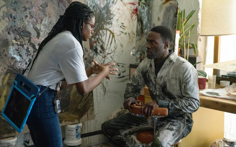 This image released by Universal Pictures director Nia DaCosta, left, with actor Yahya Abdul-Mateen II on the set of “Candyman.”