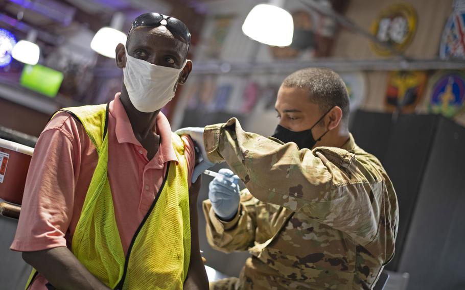 Abdoul Falah Yonis Ali receives the COVID-19 vaccine from Tech Sgt. Kevin Flenoury at Camp Lemonnier, Djibouti, in 2021. China also has a military base in Djibouti where 2,000 troops are permanently stationed, according to the Africa Center for Strategic Studies think tank.