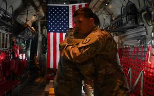 U.S. Army Col. Timothy MacDonald, operations director, Combined Joint Task Force - Horn of Africa, re-administers the Oath of Enlistment to Sgt. 1st Class Nathan Phelps, military police officer, CJTF-HOA, from Locke, New York, while aboard a KC-130J over East Africa, Sept. 11, 2021. The reenlistment occurred while flying over a Patriot’s Day ceremony at Camp Lemonnier, Djibouti, commemorating the 20th anniversary of the terrorist attacks on the United States on Sept. 11, 2001. Phelps extended his enlistment indefinitely while completing his third overseas deployment in support of the Global War on Terror. The ground ceremony included a joint formation, a multi-aircraft flyover, presentation of colors and the playing of Taps. Camp Lemonnier held multiple events in honor and remembrance of those who lost their lives both on that day and over the past two decades fighting the Global War on Terror. (U.S. Air Force photo by Tech. Sgt. Michael Cossaboom)