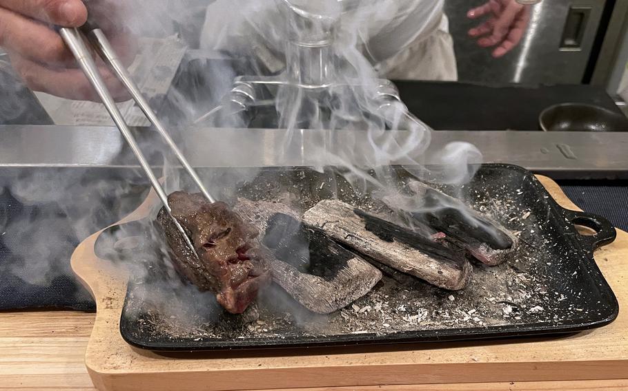 Chef Yoshinori Ito sears a slice of wagyu during an intimate meal at Mii Bee, his small eatery in Beppu, Japan. 