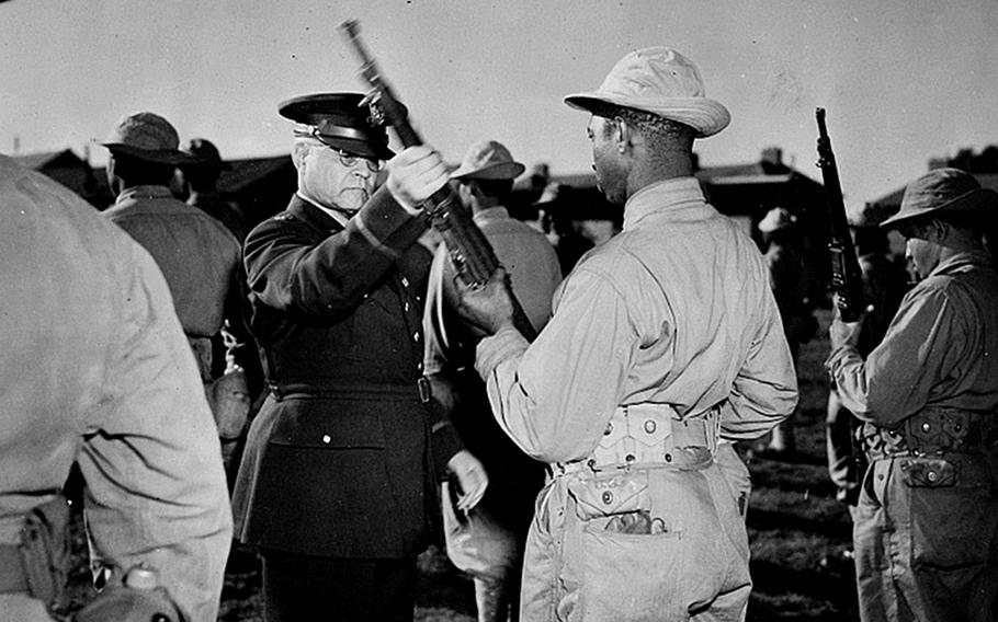 Brig. Gen. Benjamin O. Davis Sr. inspects the rifle of a U.S. African American soldier somewhere in England, probably in 1942. In September 1942, Davis was assigned to the Europe on special duty as an adviser on issues involving Black soldiers. In 1943, a bloody battle between Black and white U.S. soldiers took place at Bamber Bridge, England.