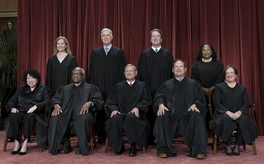 Members of the Supreme Court sit for a new group portrait following the addition of Associate Justice Ketanji Brown Jackson, at the Supreme Court building in Washington, on Oct. 7, 2022. The core issue being debated before the Supreme Court on April 25, 2024, boils down to this: Whether a former president is immune from prosecution for actions taken while in office — and, if so, what is the extent of the immunity?