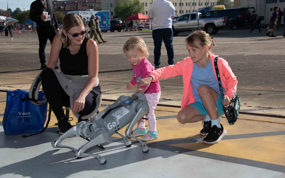 Lenka Kucera and her daughters enjoy an interactive robotic dog demonstration during the Science Technology Engineering and Mathematics (STEM) expo during the 2024 Beyond the Horizon Air and Space Show at Maxwell Air Force Base, Ala., Saturday, April 6, 2024. 