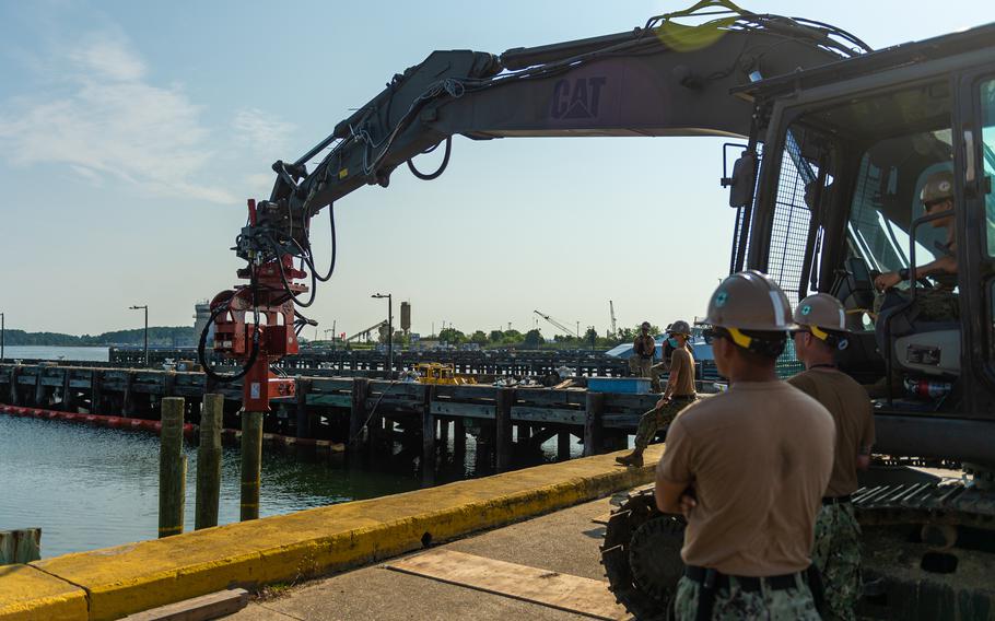 Sailors attached to Naval Mobile Construction Battalion (NMCB) 133, drive a pilon into the sea bed as part of a Pier Damage Repair scenario onboard Joint Expeditionary Base Little Creek-Fort Story in Virginia Beach, Virginia, during Large Scale Exercise 2021. LSE 2021 demonstrates the Navy's ability to employ precise, lethal, and overwhelming force globally across three naval component commands, five numbered fleets and 17 time zones.