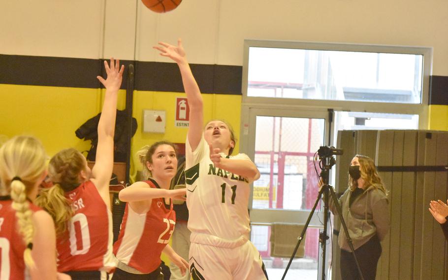 Naples' Emma Kasparek puts up a shot while surrounded by American Overseas School of Rome defenders on Friday, March 4, 2022, at the DODEA-Europe Division II basketball championships.