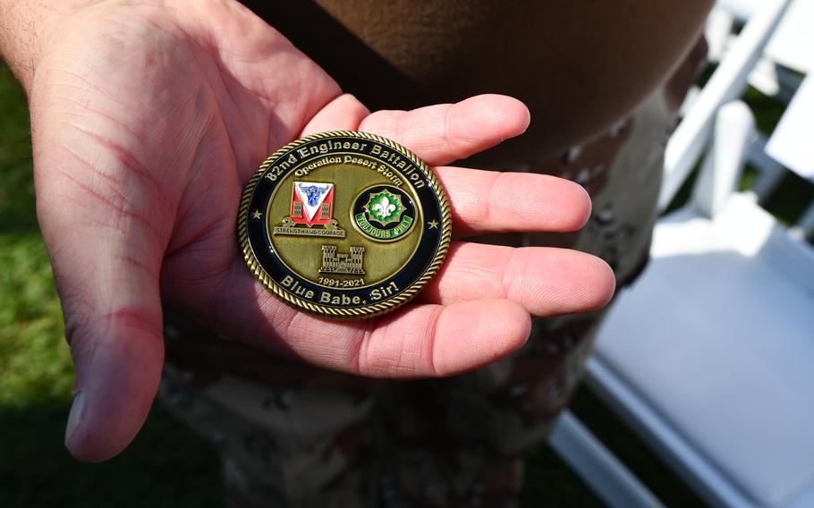 Kenneth Falls, a veteran of Operation Desert Storm, holds a commemorative coin of the U.S. conflict.