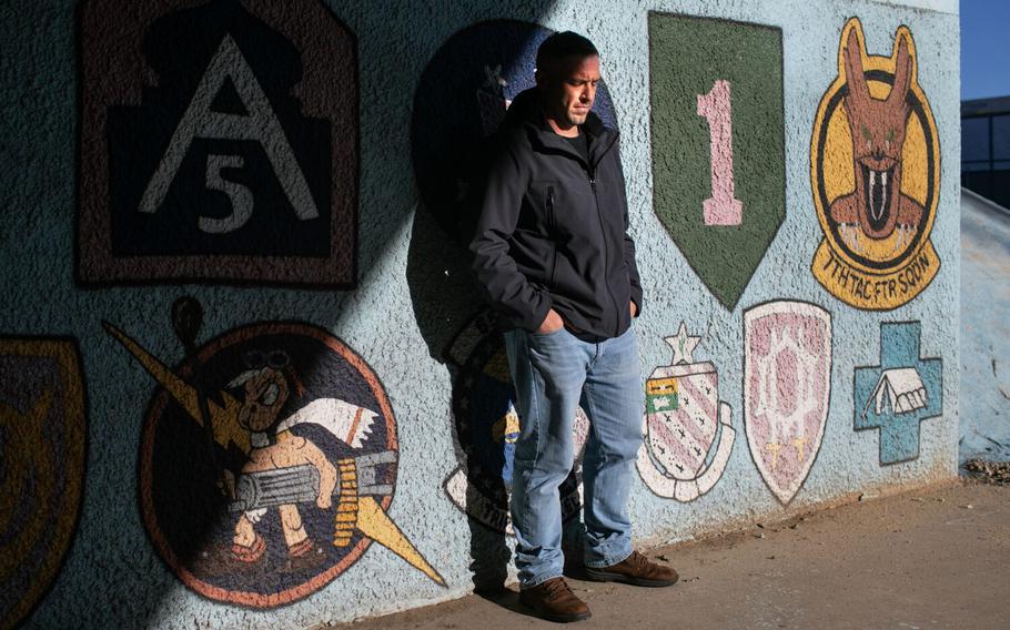 Rob Reynolds, an Army veteran, poses for a portrait by the veterans mural at Wilshire Boulevard and Bonsall Avenue near the VA Hospital in West L.A. on Tuesday, Jan. 17, 2023, in Los Angeles.