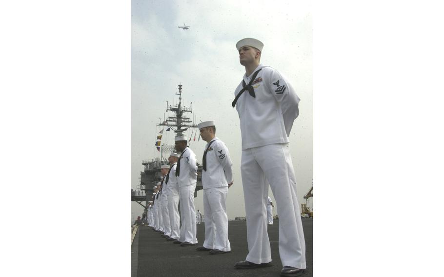 Kitty Hawk sailors man the rails as the ship pulls into Yokosuka Tuesday morning, May 6, 2003.