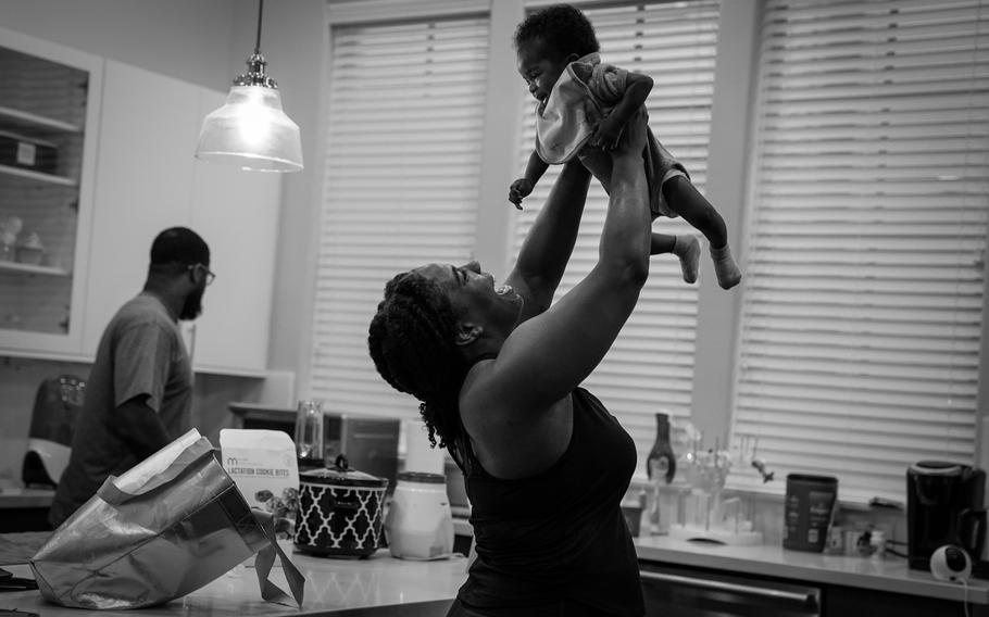 Back from her morning workout and before heading to the law firm where she works, Anderson greets her daughter in March. 