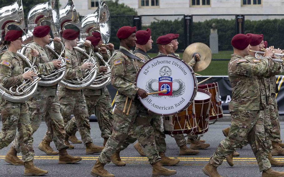 A military band plays and marches.