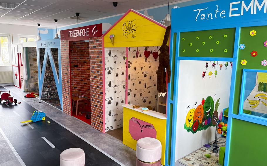 A colorful children play area designed like a small town street.