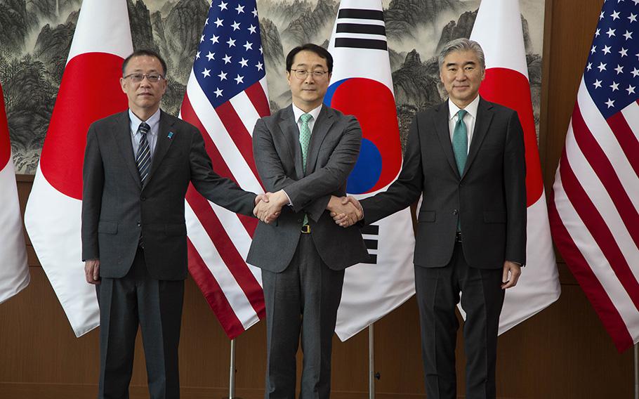 From left to right, Japanese nuclear envoy Takehiro Funakoshi, chief South Korean nuclear negotiator, Kim Gunn, and Sung Kim, the U.S. special representative to North Korea shake hands before their three-way meeting at the Foreign Ministry in Seoul, South Korea, Friday, April 7, 2023.