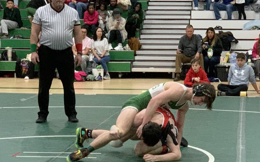 Naples' Sam Pounds, top, tries to outmaneuver Aviano's Jevan Smith during the 150-weight class final match at the DODEA Southern Europe wrestling sectionals on Saturday, Feb. 3, 2024. Pounds, who remains undefeated this season, won the match and took first in his weight class.