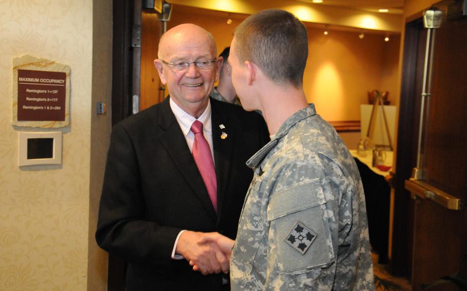 Retired Army Gen. Gordon R. Sullivan, a former service secretary and chief of staff, greets a solider in 2013. Sullivan died Tuesday, Jan. 2, 2024.