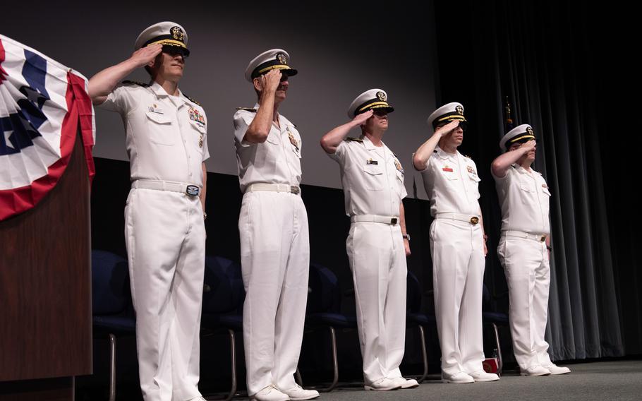 The official party salutes during a decommissioning ceremony for the Los Angeles-class fast attack submarine USS Chicago (SSN 721), in Keyport, Wash., Friday, July 21, 2023. Chicago was commissioned in 1986 and is the fourth vessel to be named after Chicago, Ill. 