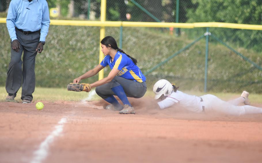 Kaiserslautern's Giada Taylor slides into third while Wiesbaden's Nicole Suh tries to grab the ball Thursday, May 22, 2025, at the DODEA-Europe Division I softball championships at Ramstein Air Base, Germany.