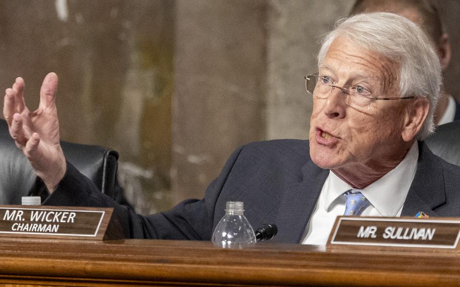 Roger Wicker gestures with his right hand as he speaks while seated on a dais in a congressional hearing room.