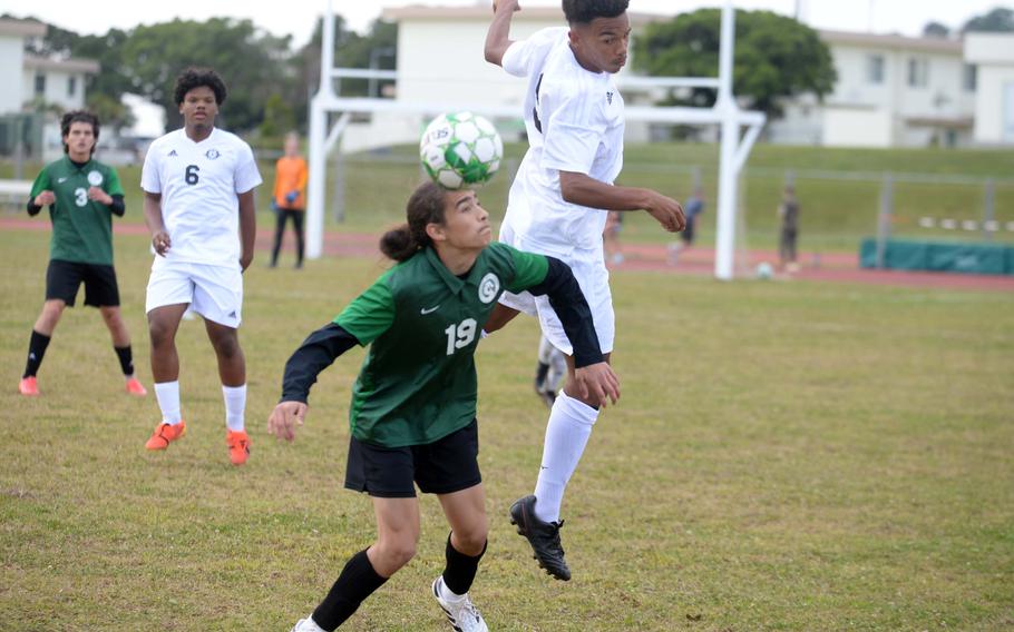 Kubasaki's Gio Armour heads the ball in front of Kadena's Elijah Whipp during Wednesday's DODEA-Okinawa boys soccer match. The Panthers won 5-0.