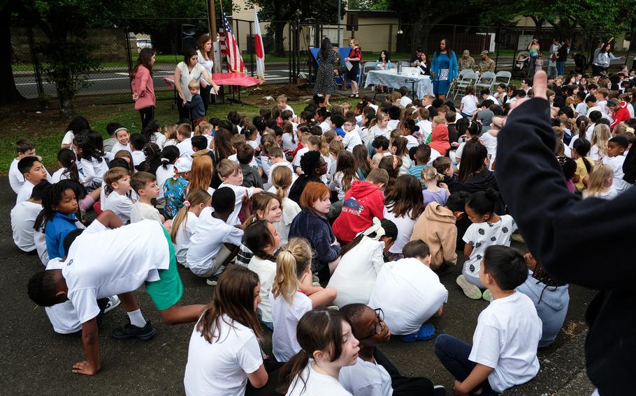A group of students and school staff members gather at an elementary school on Yokota Air Base. 
