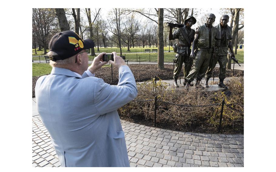 Vietnam veteran Philip Todd, from Arizona, takes a photo of the Three Soldiers statue at the the Vietnam Veterans Memorial in Washington, D.C., March 29, 2024.