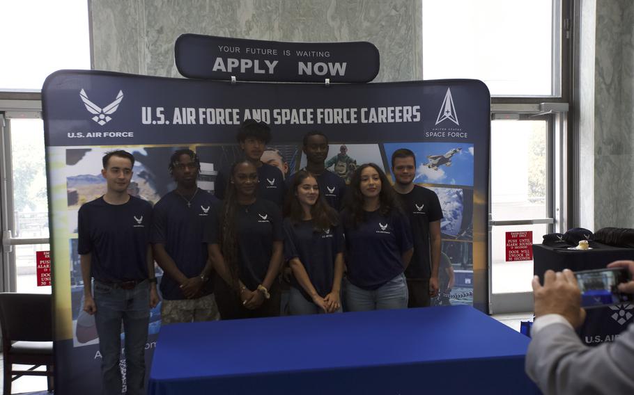 Men and women in Air Force t-shirts posing for a photo.