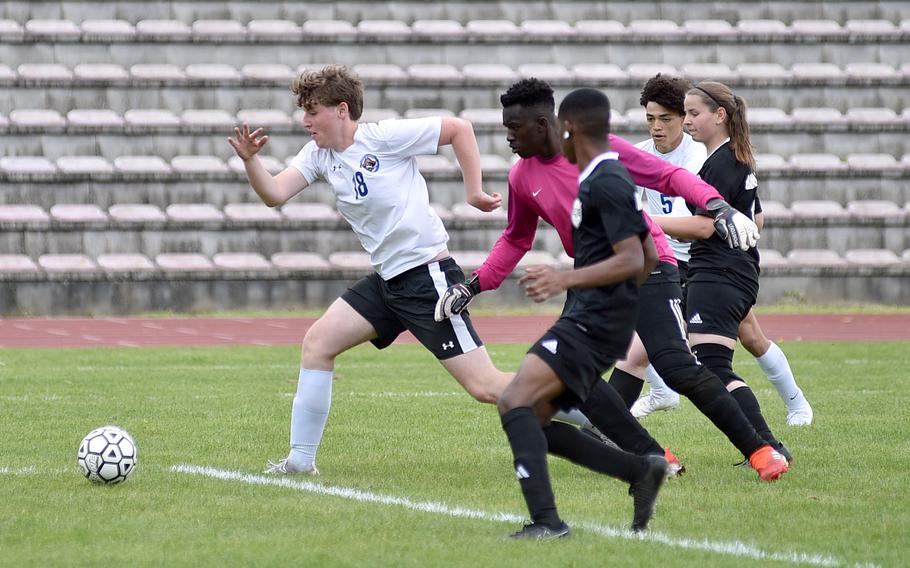 Brussels striker Nandor Arnold leads a group Buccaners, from left, Elijah Washington, Justin Anderson and Ashlyn Brech, to the ball during a May 4, 2024, match at Minick Field in Baumholder, Germany.