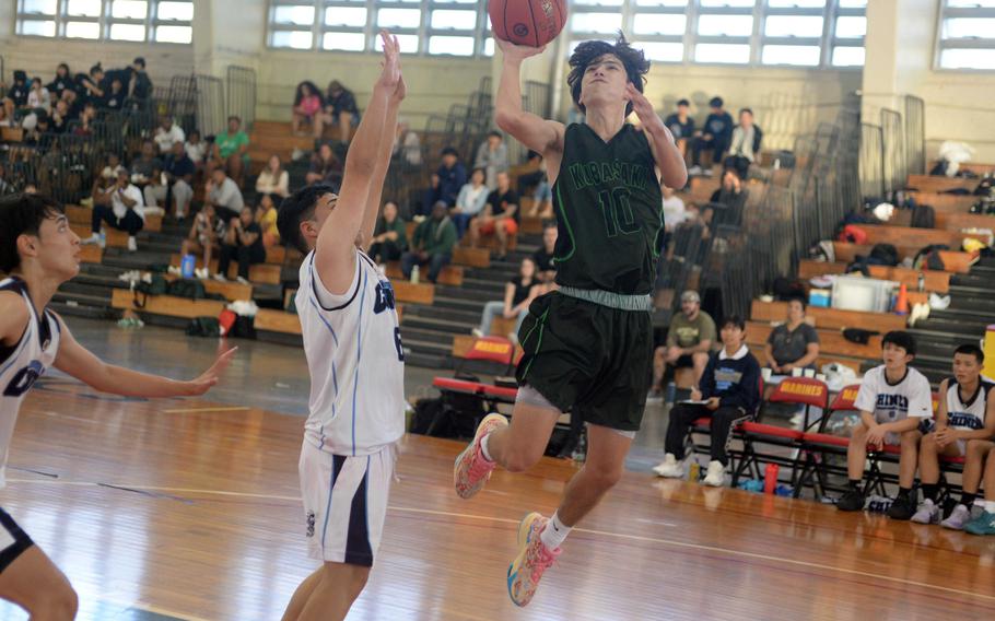 Kubasaki's Troy Harris skies for a shot against Chinen during Saturday's Okinawa-American Friendship Tournament pool-play game. The Dragons won 61-37.