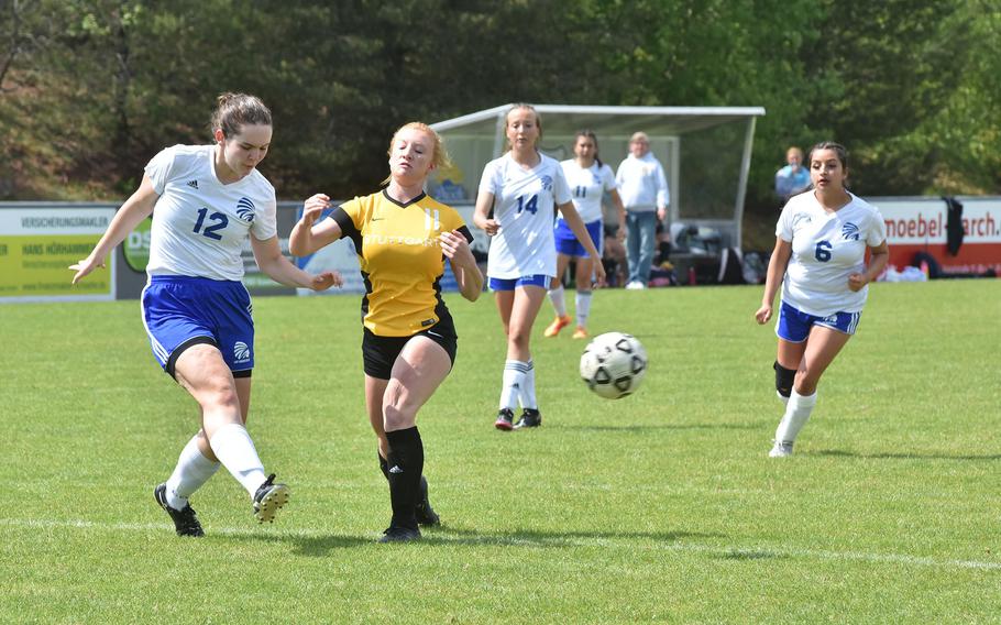 Wiesbaden's Hannah Buccheit kicks the ball away right before Stuttgart's Bella Henderson can get to her in the Panthers' 4-1 victory over the Warriors in the semifinals of the DODEA-Europe Division I girls championship Wednesday, May 17, 2023.