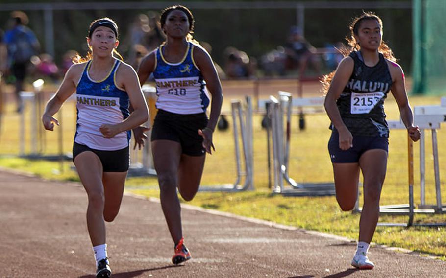 Guam High junior Kailee Guerrero charges toward the finish line of the 100 in Monday's All-Island meet. Guerrero finished first, Simon Sanchez sophomore Erica Palisoc finished second and Panthers senior Amoni Washington, middle, took fifth.