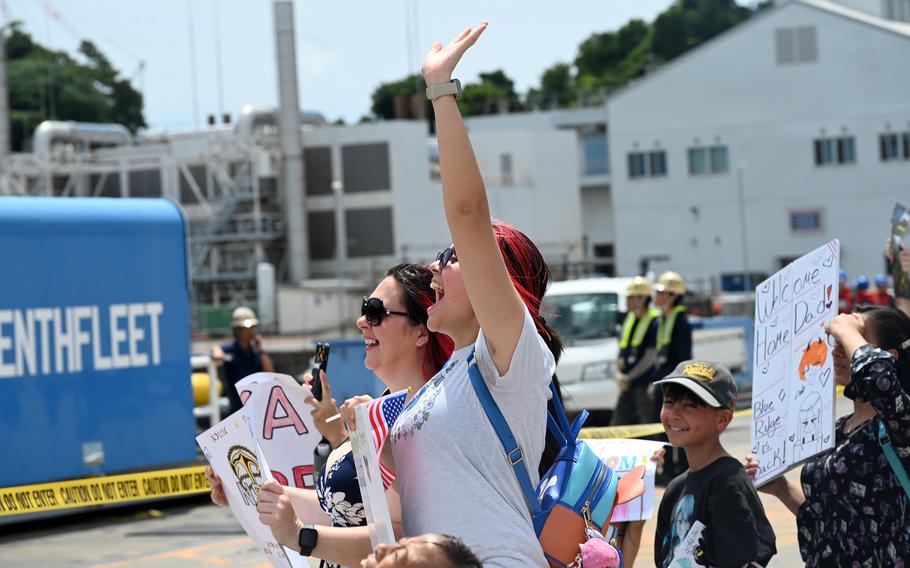 Friends and family of USS Blue Ridge sailors crowd the pier as the amphibious command ship returns.