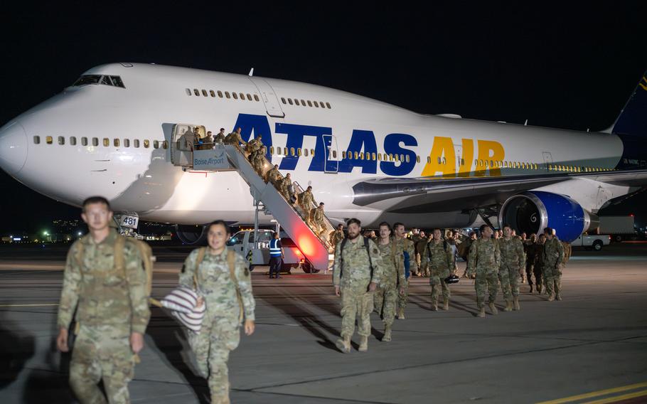 Airmen walk off a plane