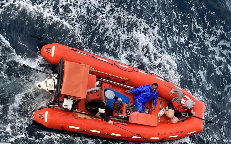 U.S. Army mariners rescue an Indonesian fisherman, center, whose boat capsized 10 miles off Obi Island, Indonesia, Sept. 1, 2023. 