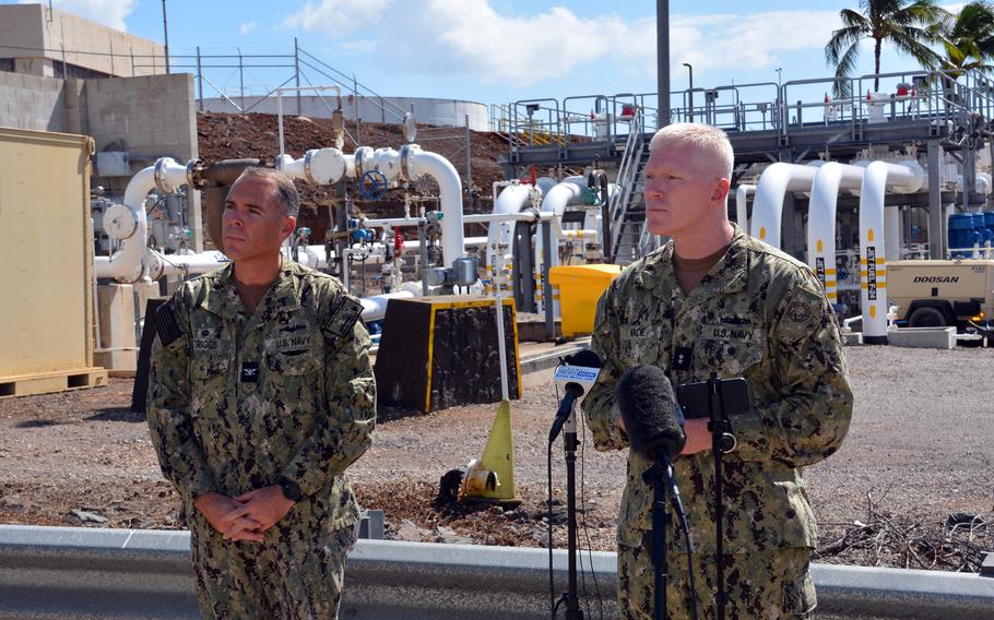 Joint Task Force-Red Hill Commander Rear Adm. John Wade, right, and Capt. Shawn Triggs, commander of Naval Supply Fleet Logistics, Pearl Harbor, field questions from reporters at Joint Base Pearl Harbor-Hickam, Hawaii, Oct. 24, 2022, near pipelines connected to the Red Hill underground storage facility.