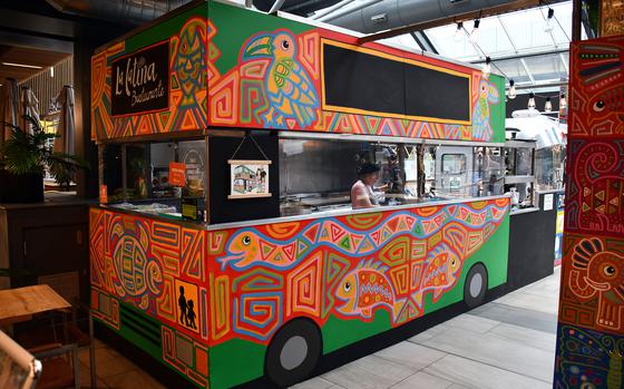 The entrance to La Latina Bustaurante in Cambridge, England, on Oct. 25, 2023. Owners Nelson and Catalina Uribe opened their business by transforming a double-decker bus into a restaurant, and they pay homage to those origins at their current location. 