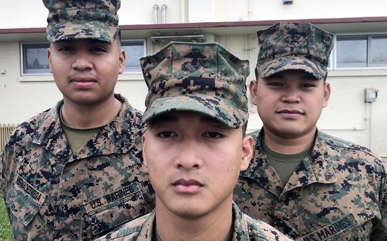 Lance Cpl. David Hernandezvega, left to right, Cpl. Aljie Alcantara and Lance Cpl. Vivencio Bio III pose at Camp Kinser, Okinawa, Nov. 17, 2022. The Marines, along with Lance Cpl. Eds Cambronero, not pictured, were honored recently by Okinawa police for rescuing a local woman from a rip current. 
