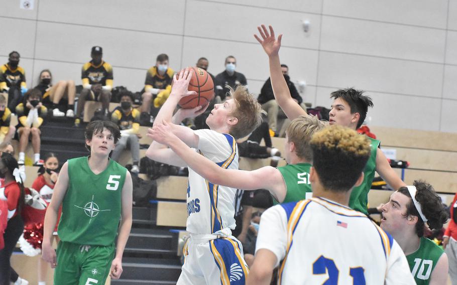 Wiesbaden's Samuel Ballenger works his way between SHAPE defenders to score Wednesday, Feb. 23, 2022, at the DODEA-Europe Division I basketball championships.