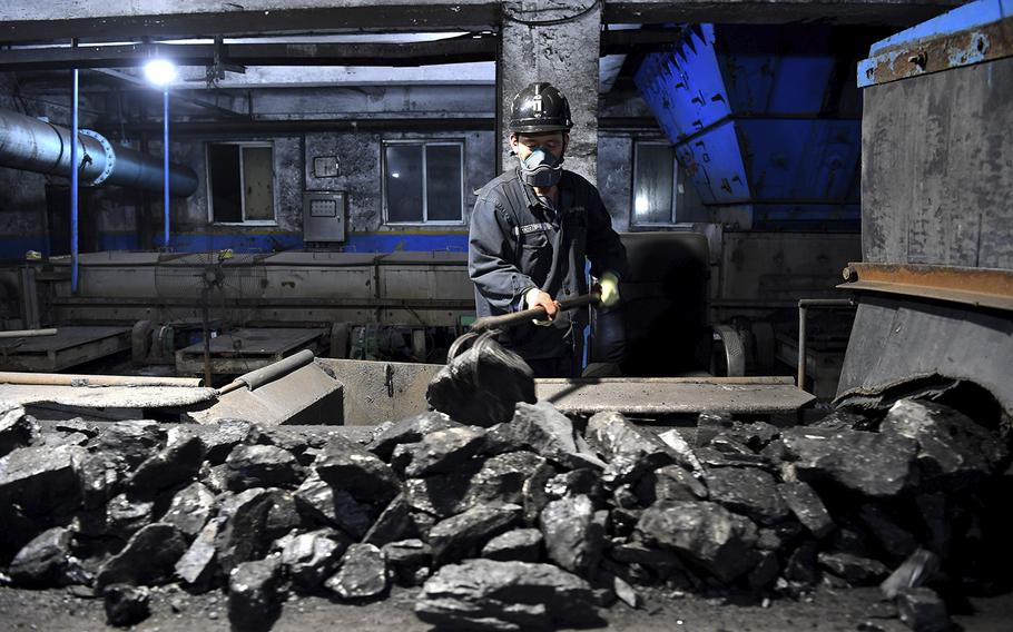 A worker sorts coals at Qianyingzi coal mine in Suzhou, east China’s Anhui Province on Oct. 20, 2021. 