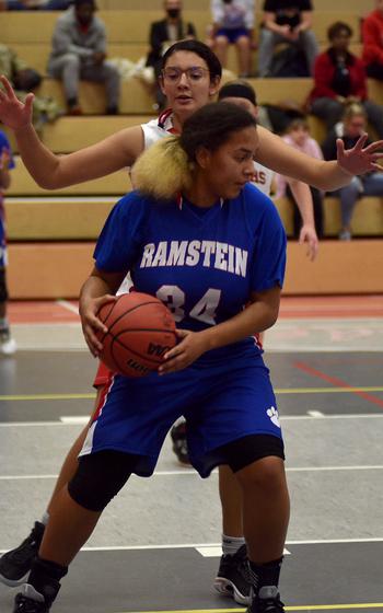 Ramstein’s Alysha Edwards, front, backs down Kaiserslautern’s Emma Arambula during Tuesday’s game at Kaiserslautern High School. The Royals won, 50-19.